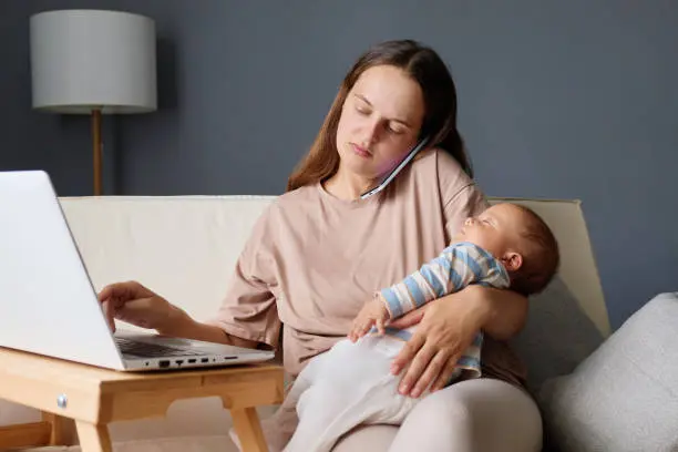 blog-1 A woman holding her baby while sitting on the couch